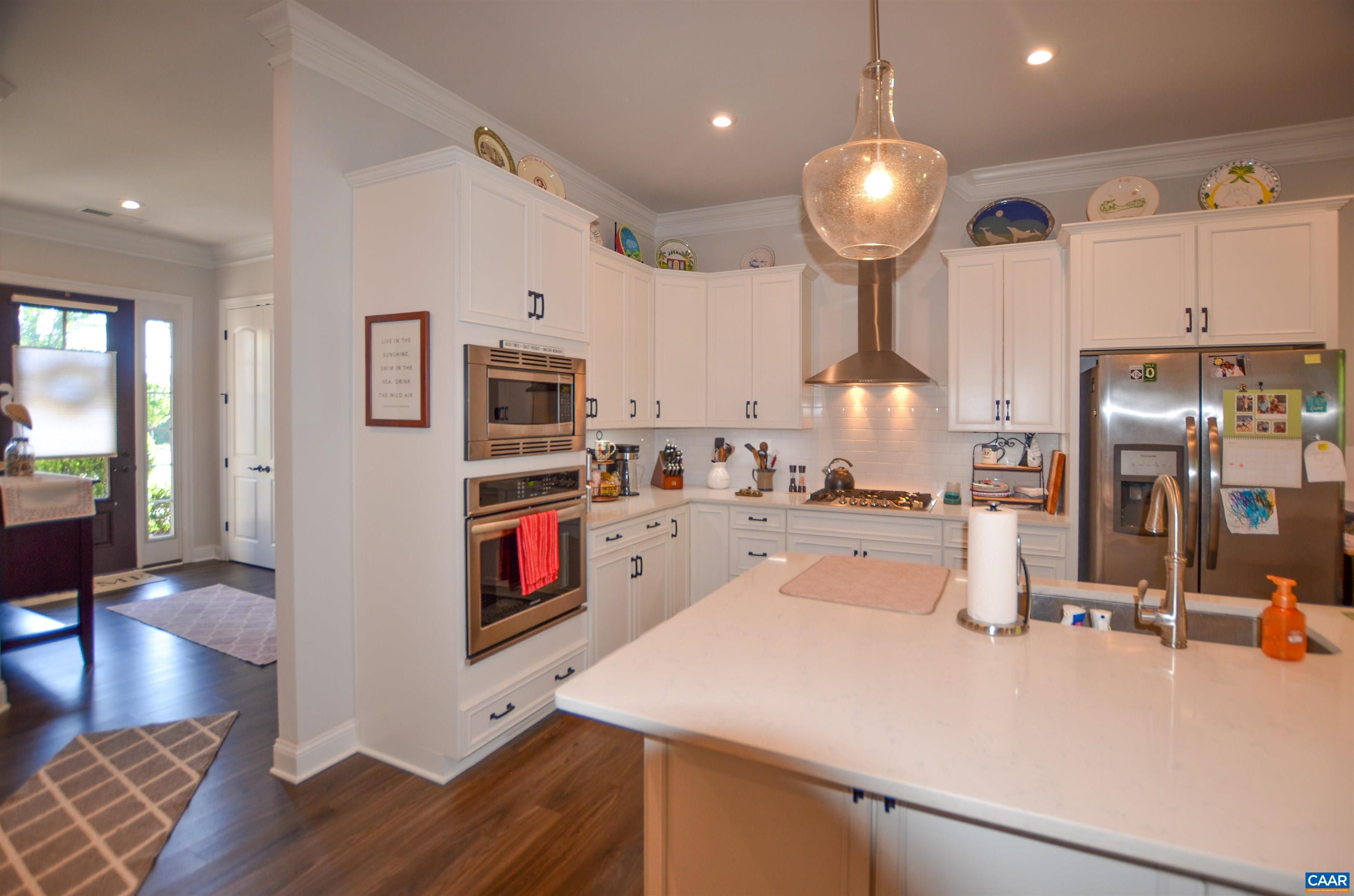 327 Claibourne Road Crozet, VA 22932 - Photo 9 of 36 a large kitchen with stainless steel appliances a large counter top a stove and a wooden floors