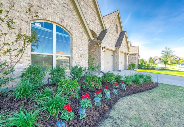 a view of a house with a big yard and large trees