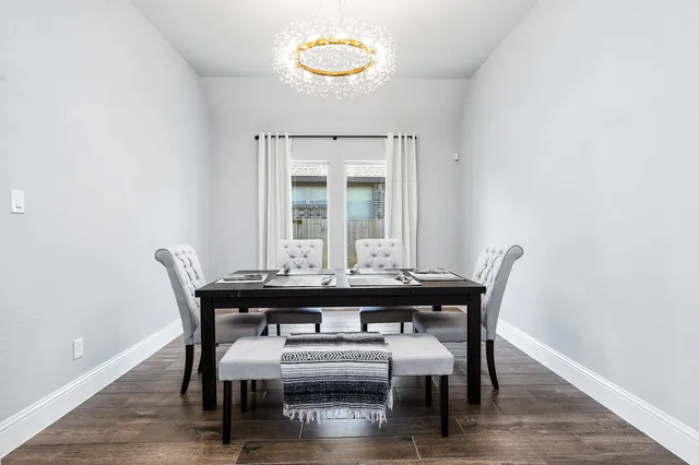 a view of a dining room with furniture and wooden floor