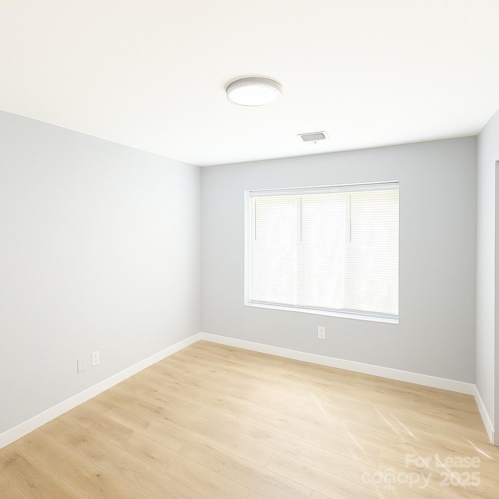 2025 Tyvola Road Charlotte, NC 28210 - Photo 11 of 16 an empty room with a window