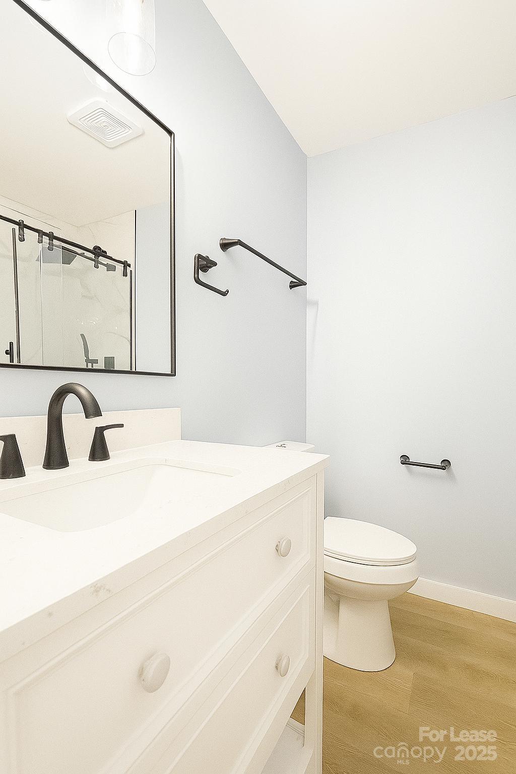 2025 Tyvola Road Charlotte, NC 28210 - Photo 13 of 16 a bathroom with a sink and a toilet