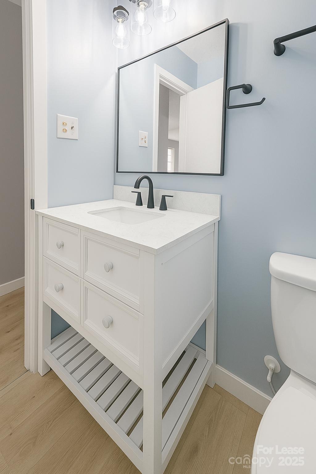 2025 Tyvola Road Charlotte, NC 28210 - Photo 15 of 16 a bathroom with a sink and a toilet