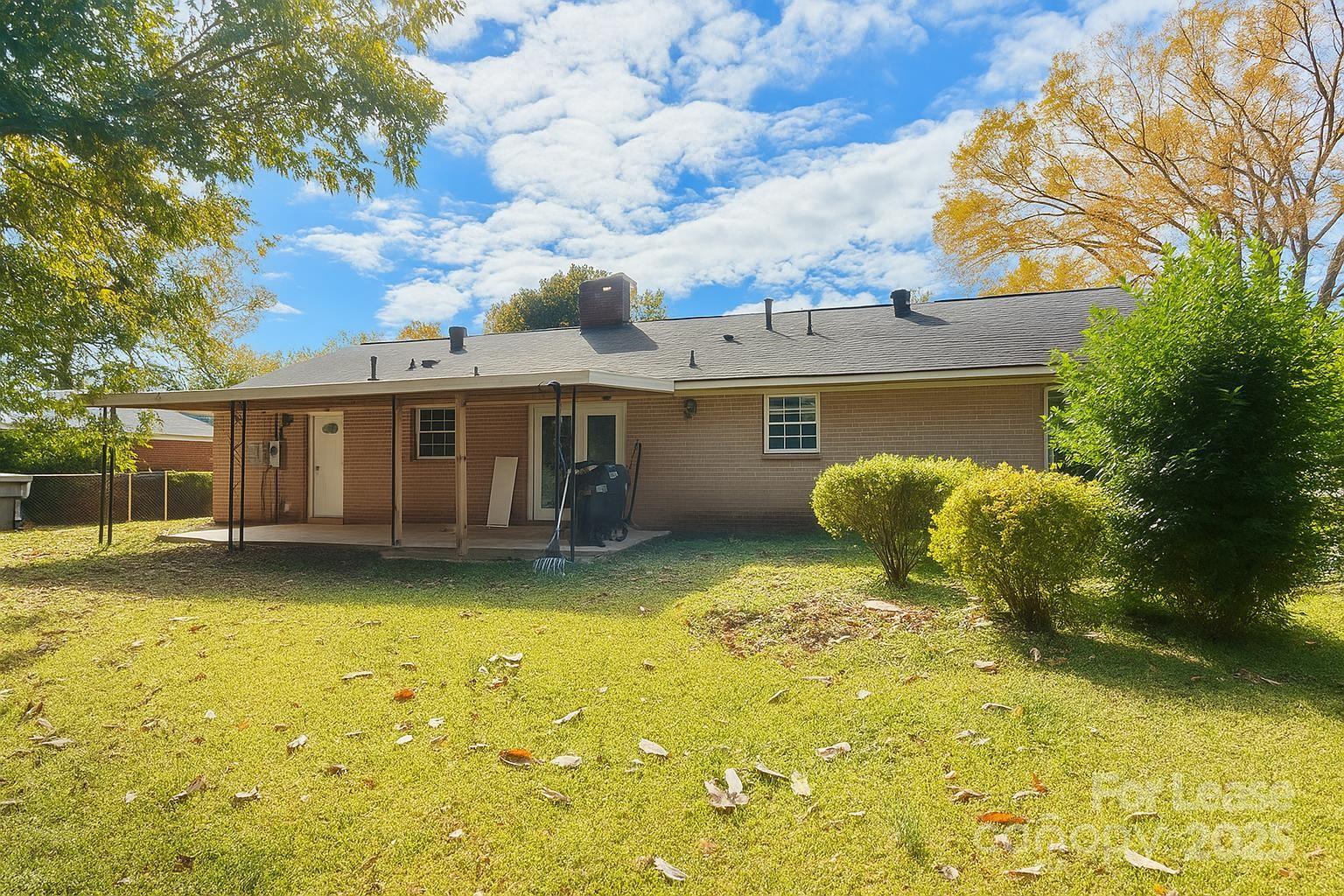 2025 Tyvola Road Charlotte, NC 28210 - Photo 16 of 16 a view of a house with a large tree and a yard