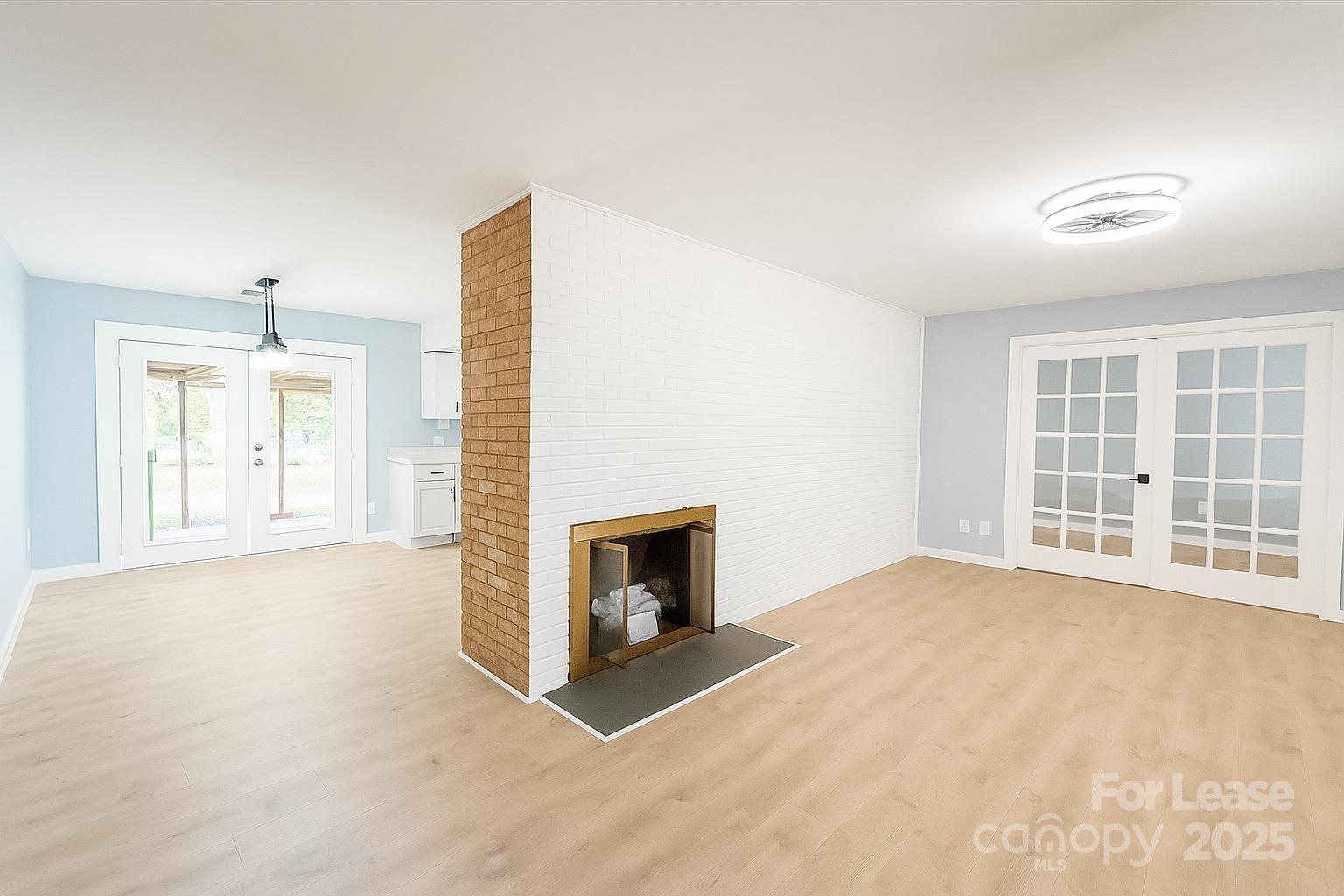 2025 Tyvola Road Charlotte, NC 28210 - Photo 2 of 16 an empty room with windows and fireplace