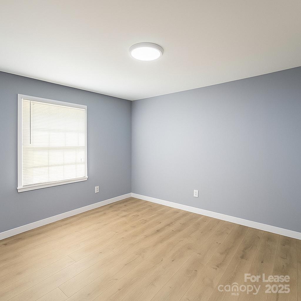 2025 Tyvola Road Charlotte, NC 28210 - Photo 7 of 16 an empty room with a window