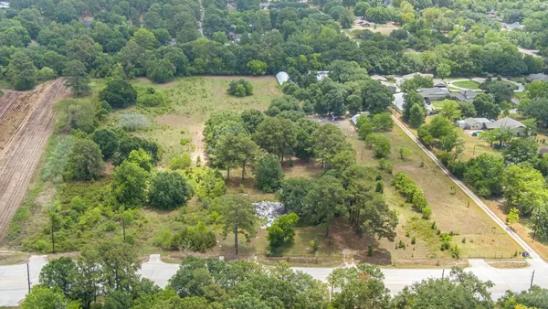 an aerial view of residential houses with outdoor space and street view