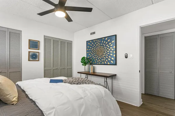 a bedroom with a bed and a chandelier