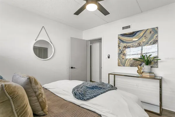 a bedroom with a bed and a mirror