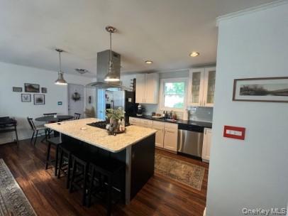 1241 Stony Brook Road Lake Grove, NY 11755 - Photo 2 of 10 a kitchen with stainless steel appliances a kitchen island hardwood floor sink stove dining table and chairs