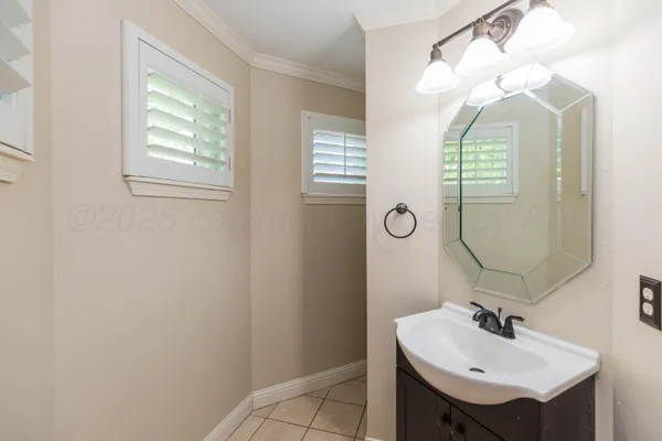 a bathroom with a sink double vanity granite tub shower and a mirror