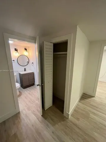 a view of a hallway with wooden floor and glass doors