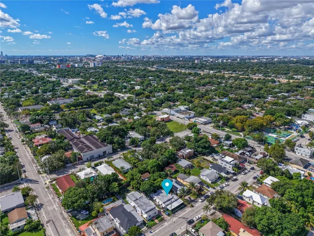 an aerial view of residential houses with outdoor space and a lake view