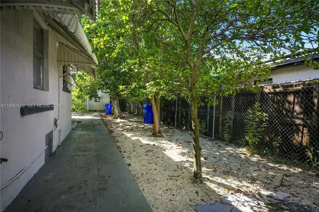 a view of a road with plants and a trees