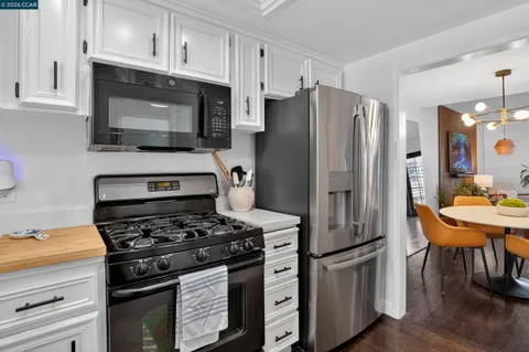 a kitchen with stainless steel appliances a stove a microwave and a refrigerator