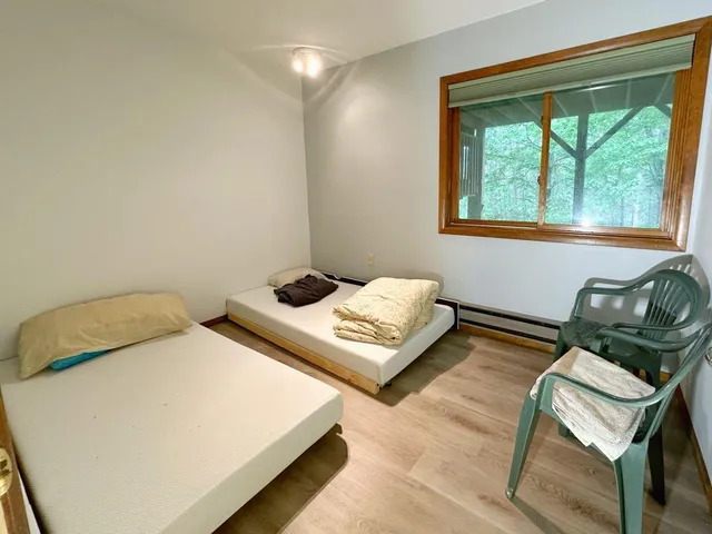 a bedroom with a bed and window