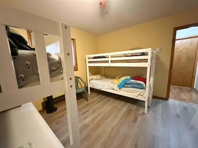 a bedroom with a bed and a mirror