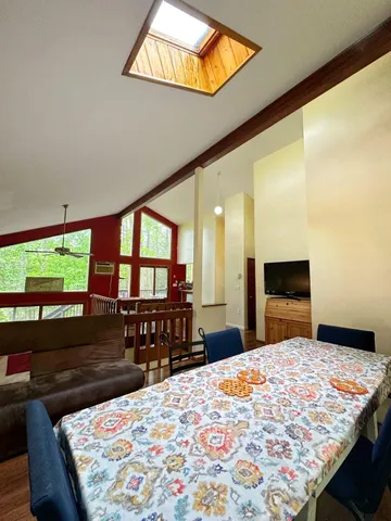 a bedroom with a bed and a dresser next to a window