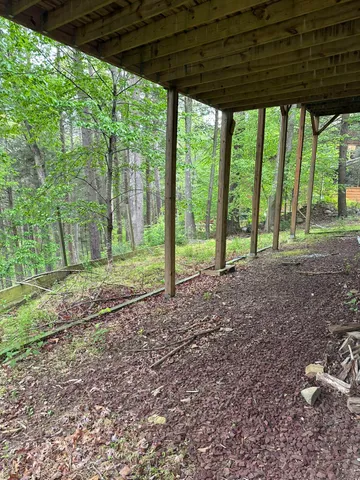 a view of a yard with porch and a trees