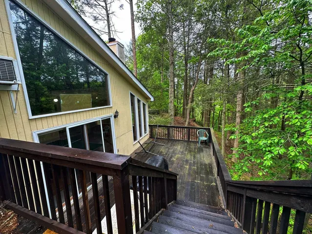 a view of house with backyard and deck