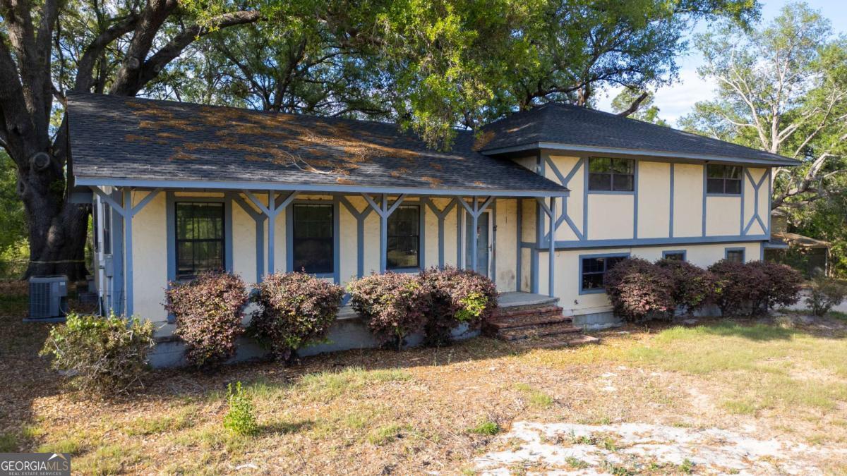 a front view of a house with garden