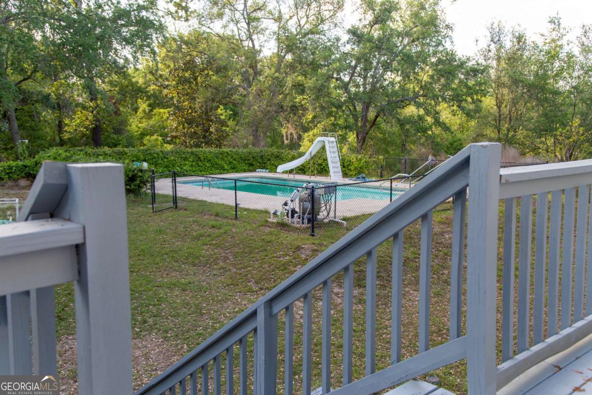 528 Gardner Road Baxley, GA 31513 - Photo 14 of 39 a view of deck with a large trees and wooden fence