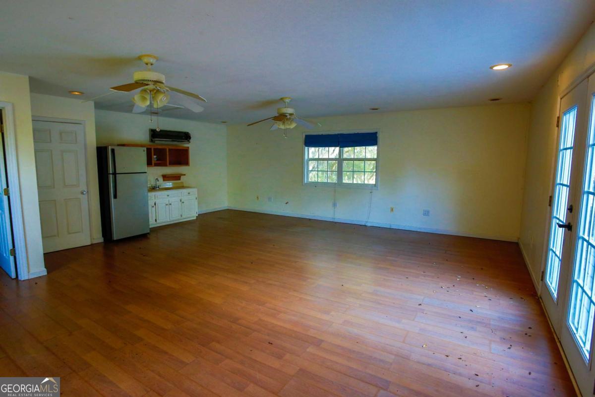 528 Gardner Road Baxley, GA 31513 - Photo 15 of 39 wooden floor in an empty room with a window