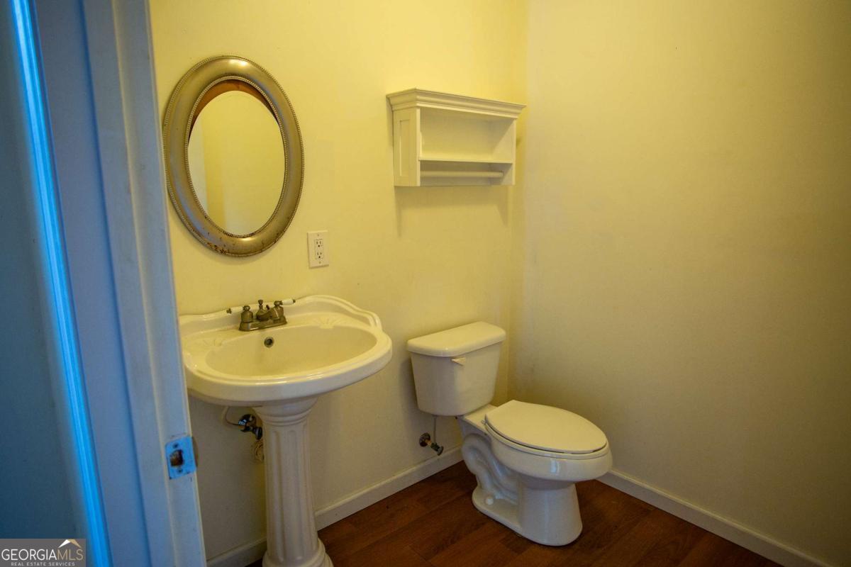 528 Gardner Road Baxley, GA 31513 - Photo 17 of 39 a bathroom with a toilet a sink and a mirror