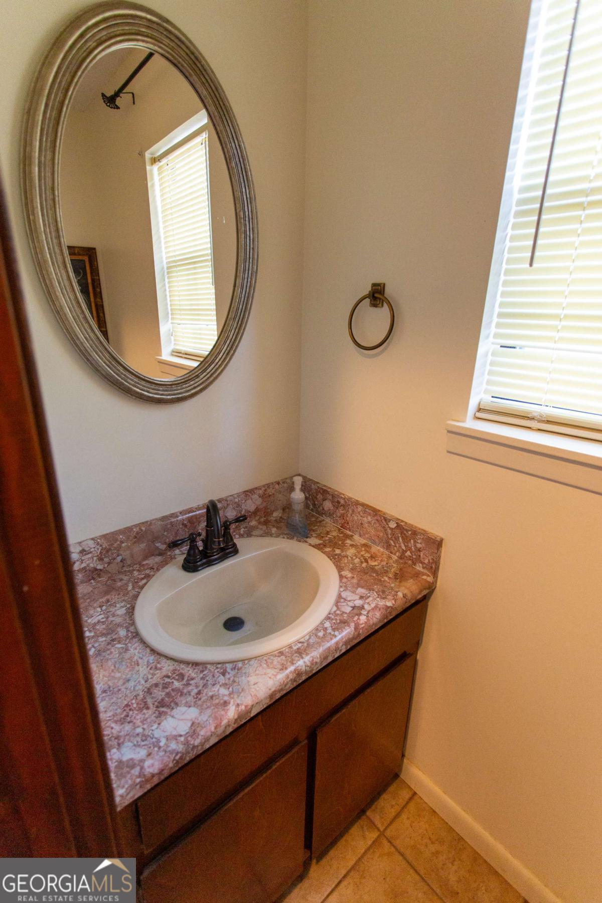 528 Gardner Road Baxley, GA 31513 - Photo 22 of 39 a bathroom with a granite countertop sink and a mirror