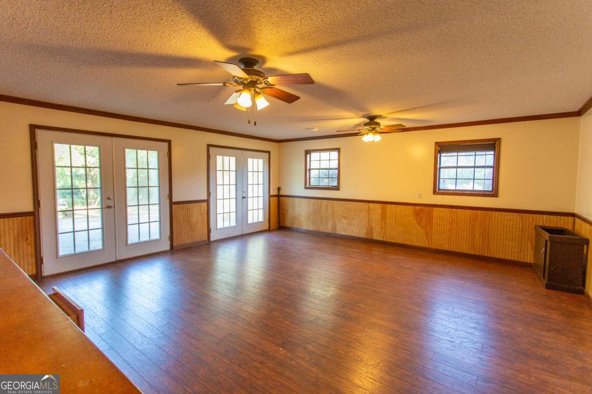 528 Gardner Road Baxley, GA 31513 - Photo 24 of 39 a view of an empty room with wooden floor and a window