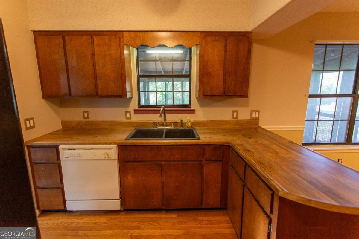 528 Gardner Road Baxley, GA 31513 - Photo 28 of 39 a kitchen with a sink cabinets and wooden floor