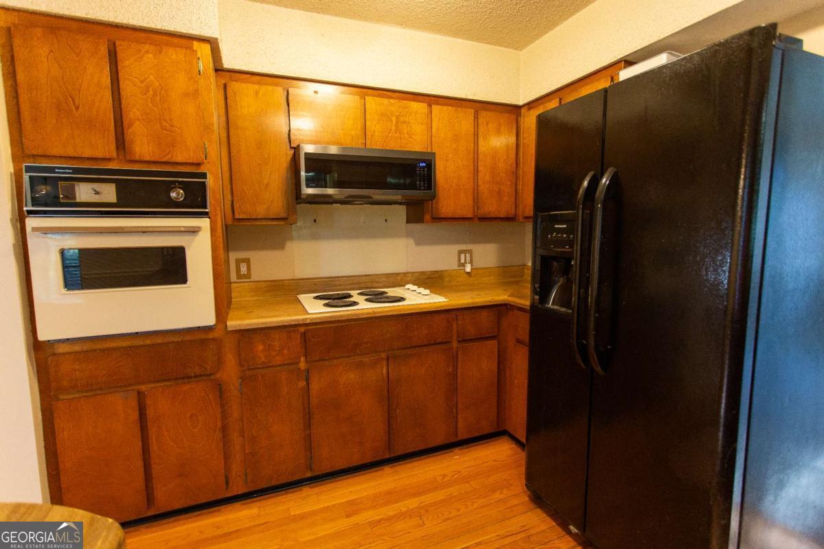 528 Gardner Road Baxley, GA 31513 - Photo 29 of 39 a kitchen with stainless steel appliances granite countertop a refrigerator and a stove top oven