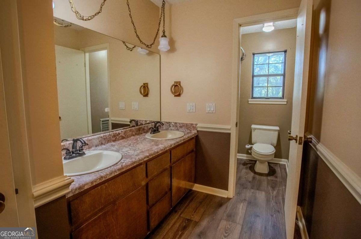 528 Gardner Road Baxley, GA 31513 - Photo 34 of 39 a bathroom with a granite countertop sink toilet and shower