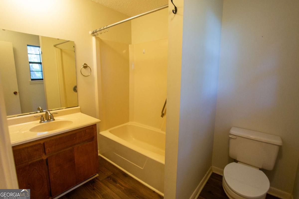 528 Gardner Road Baxley, GA 31513 - Photo 38 of 39 a bathroom with a granite countertop sink toilet and shower