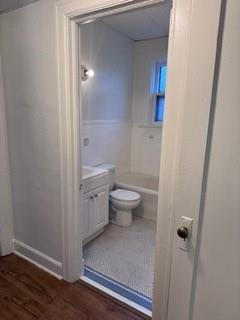 1821 9th Street, Unit B Wichita Falls, TX 76301 - Photo 12 of 14 a bathroom with a granite countertop toilet and a sink