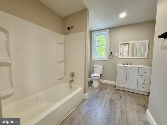 a view of bathroom with a toilet sink and a mirror