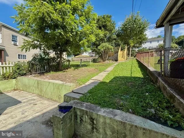 a view of balcony with wooden fence and plants