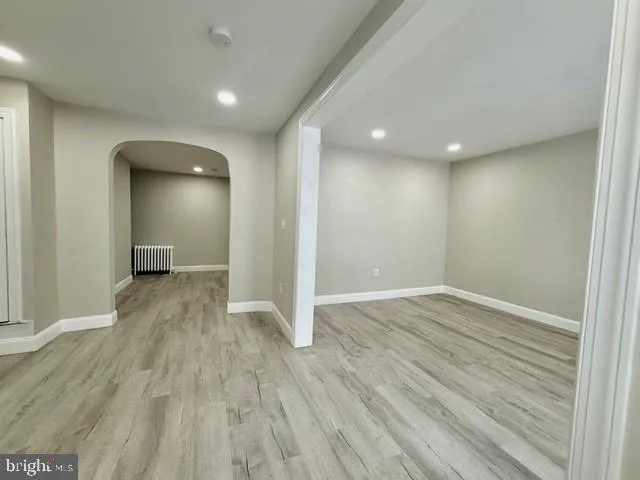 a view of a room with wooden floor and a window