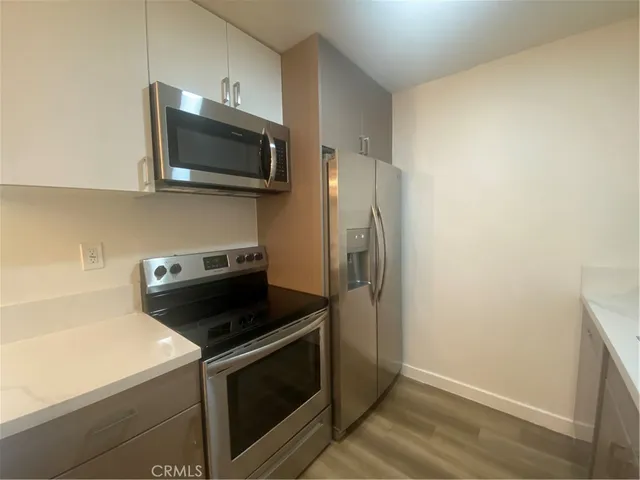 a kitchen with a microwave and a stove