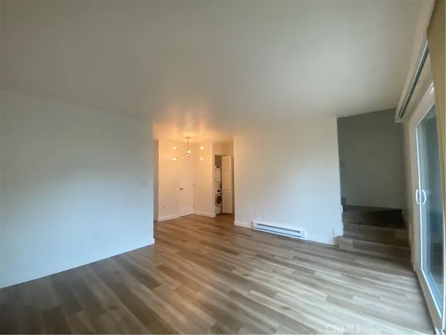 a view of an empty room and wooden floor