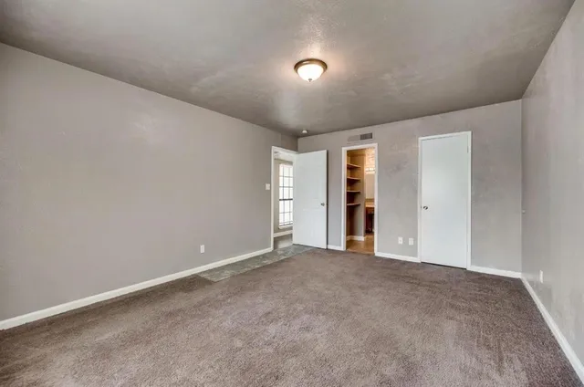 a view of an empty room with an entryway