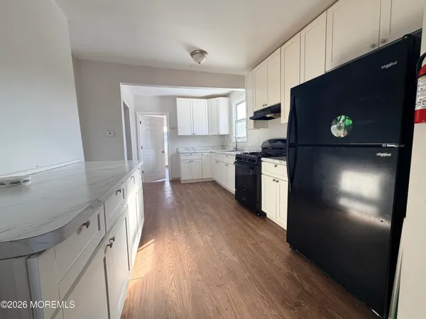 a kitchen with a refrigerator and a stove top oven