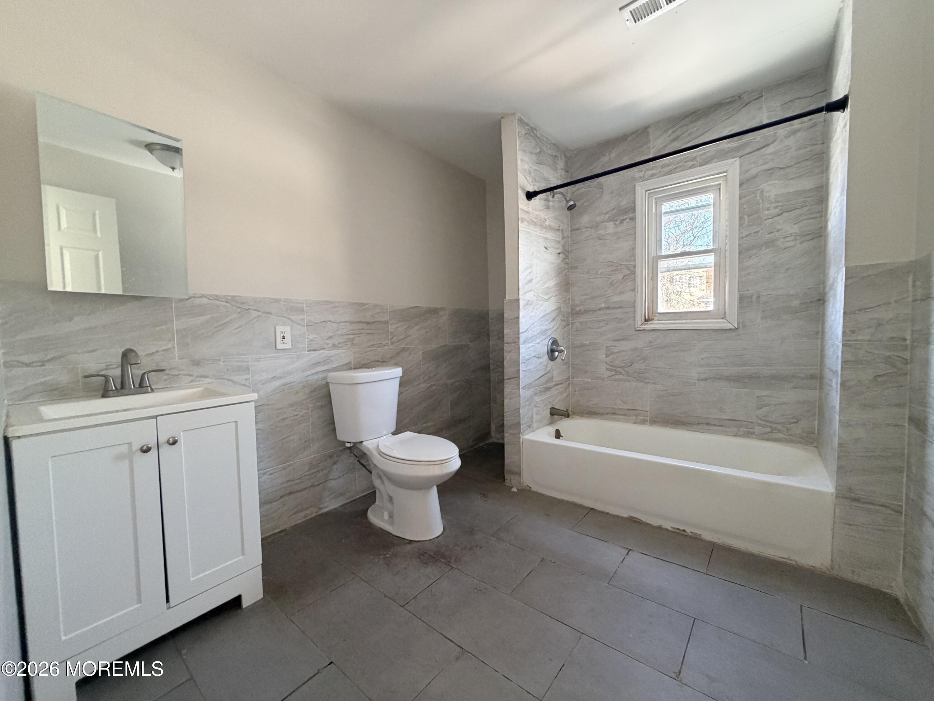 101-103 Ridge Avenue Asbury Park, NJ 07712 - Photo 7 of 11 a bathroom with a toilet sink and bathtub