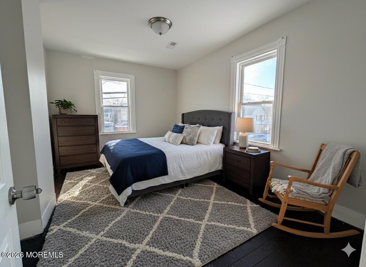 101-103 Ridge Avenue Asbury Park, NJ 07712 - Photo 8 of 11 a bedroom with a bed and windows