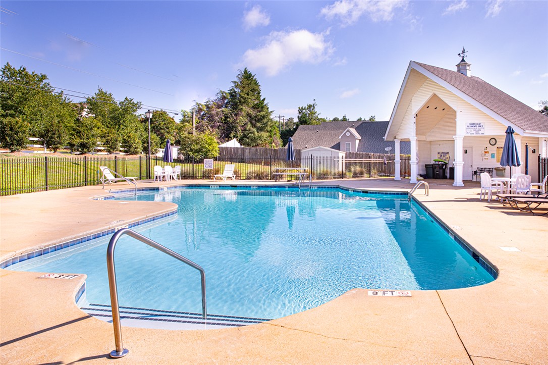 735 Britton Street Anderson, SC 29621 - Photo 49 of 50 A sparkling pool invites relaxation, bordered by a well-maintained deck and covered amenity space.