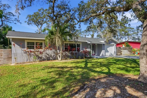 a front view of house with yard and green space