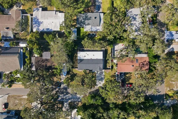 an aerial view of a house with a yard and garden