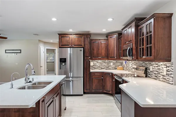 a kitchen with stainless steel appliances granite countertop a sink stove and refrigerator