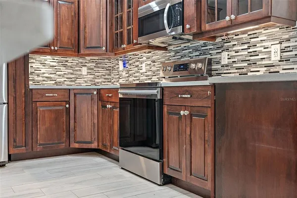 a kitchen with stainless steel appliances granite countertop a sink and cabinets