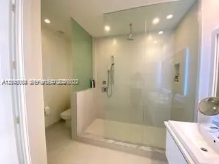 a bathroom with a double vanity sink mirror and shower
