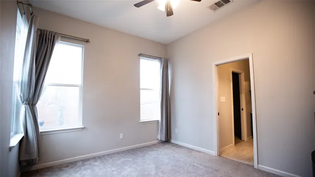 an empty room with windows and closet